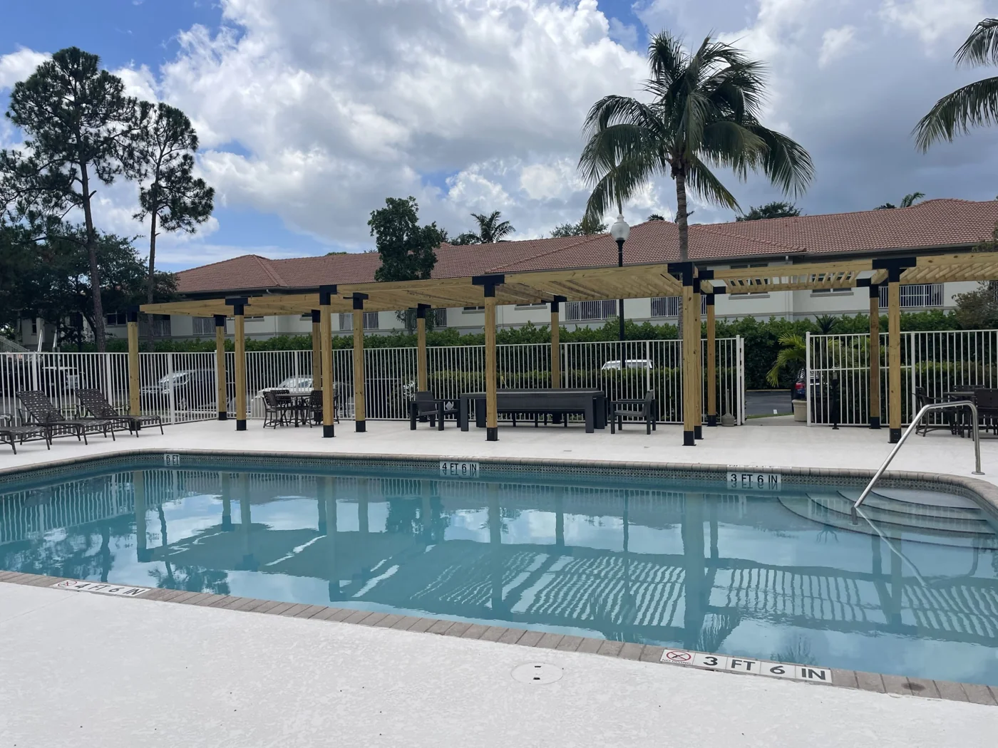 Community swimming pool with new timber pergolas and outdoor seating